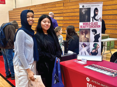 two female students smiling at camera